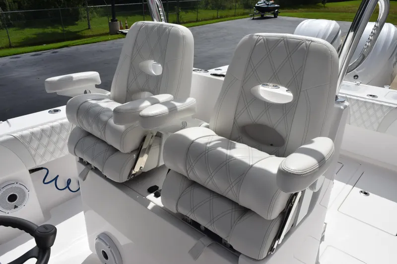 Slide: The Image of Luxury seating on 2025 Contender 35 ST boat, featuring plush white upholstery and armrests. - 13