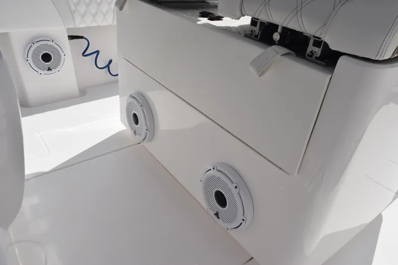 Slide: The Image of 2025 Contender 35 ST boat interior with speakers and cushioned seating. - 14
