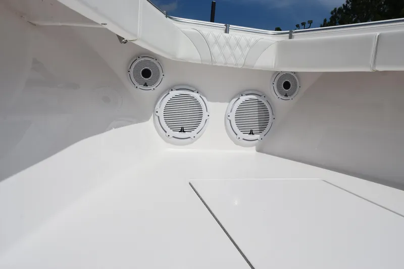 Slide: The Image of 2025 Contender 35 ST boat interior with built-in speakers, white seating, and sleek design. - 16