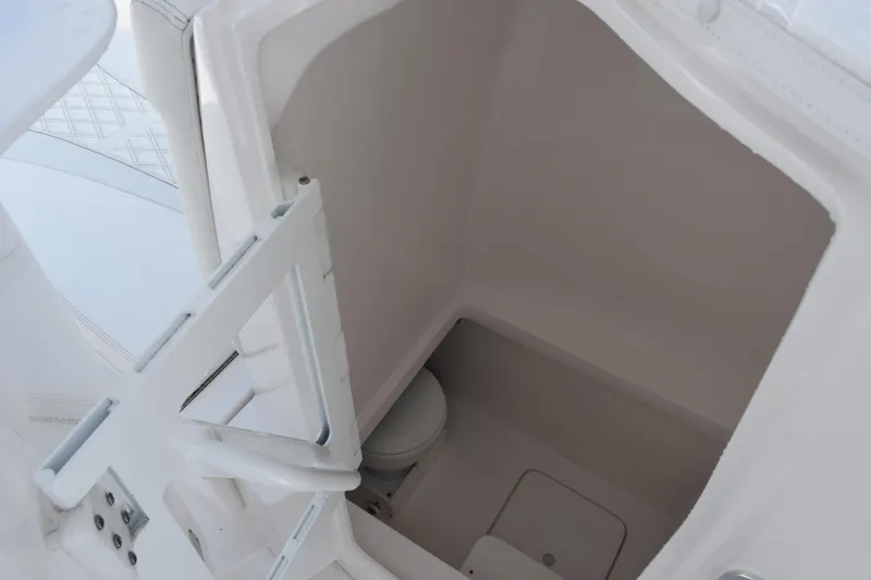 Slide: The Image of Interior of 2025 Contender 35 ST boat, featuring a compact marine toilet. - 20