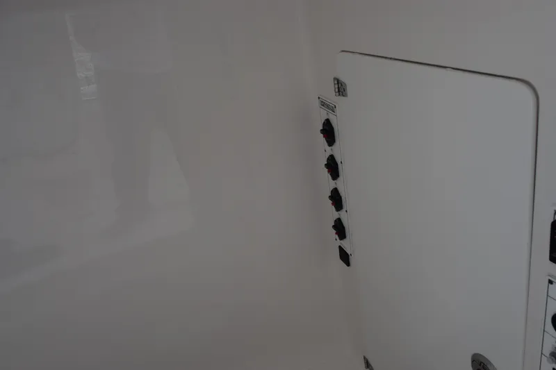 Slide: The Image of Interior view of 2025 Contender 35 ST boat showing control panel and storage compartment. - 22