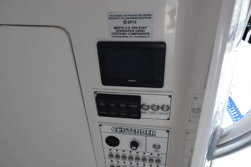 Slide: The Image of Control panel of 2025 Contender 35 ST boat with Yamaha display and switches. - 23