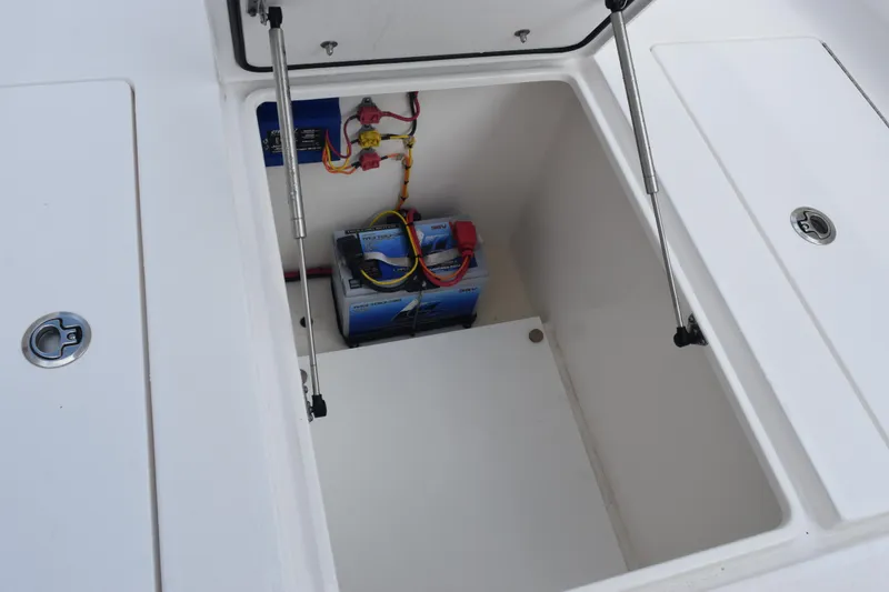 Slide: The Image of 2025 Contender 35 ST boat storage compartment with battery and wiring. - 29