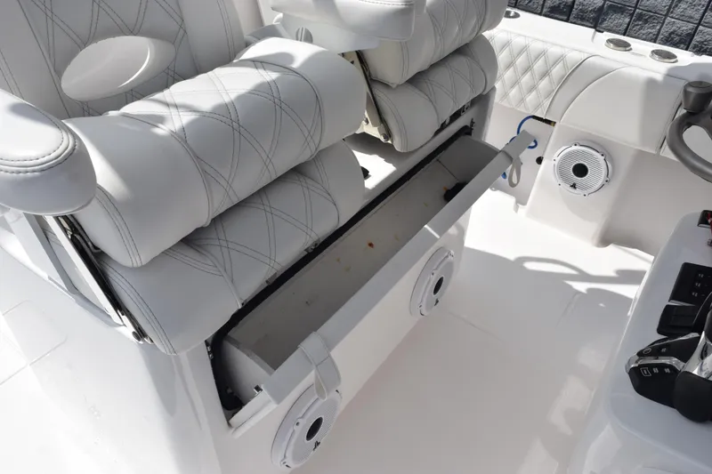 Slide: The Image of 2025 Contender 35 ST boat interior with white cushioned seating and storage compartment. - 36