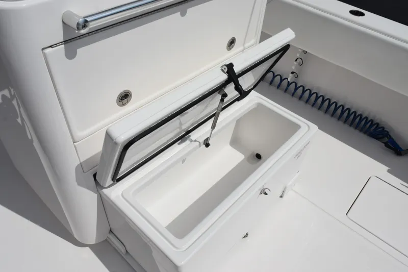 Slide: The Image of Open storage compartment on 2025 Contender 35 ST boat, featuring a white interior. - 38