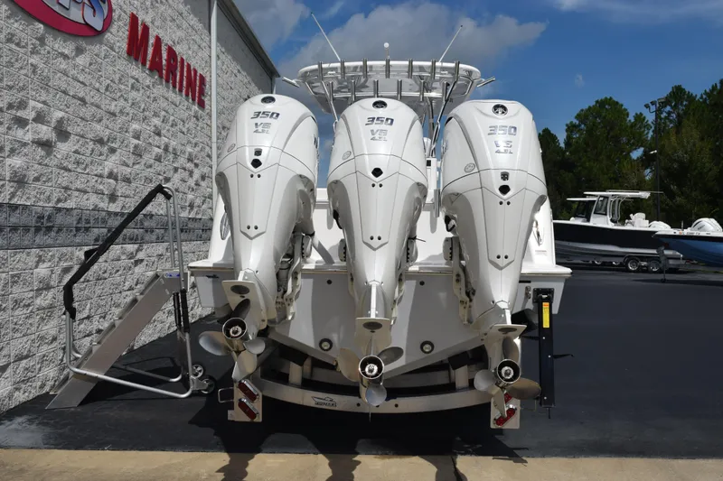 Slide: The Image of 2025 Contender 35 ST boat with triple 350 V8 engines displayed at a marine dealership. - 5