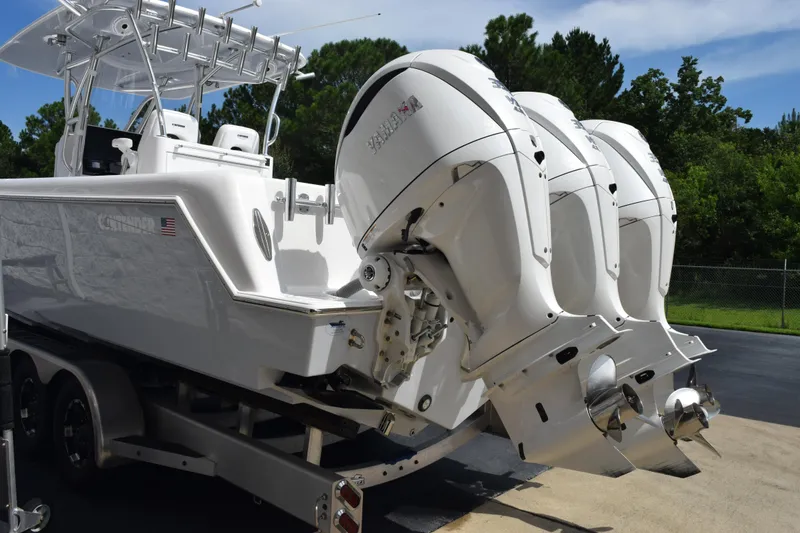 Slide: The Image of 2025 Contender 35 ST boat with triple outboard engines on a trailer. - 6