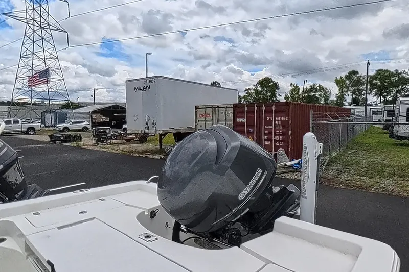 Slide: The Image of 2012 Sportsman Masters 227 Bay Boat with Yamaha engine in a storage yard. - 11