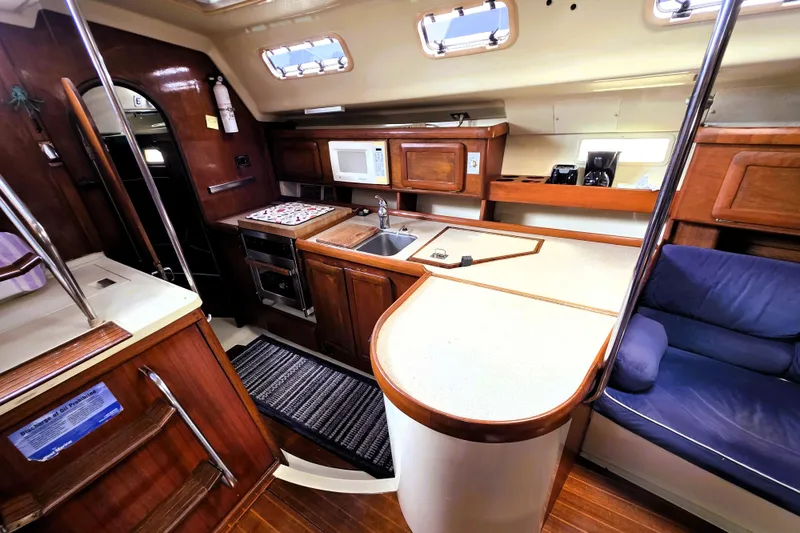 Slide: The Image of Interior of 1992 Hunter 43 Legend yacht with kitchen and seating area. - 10
