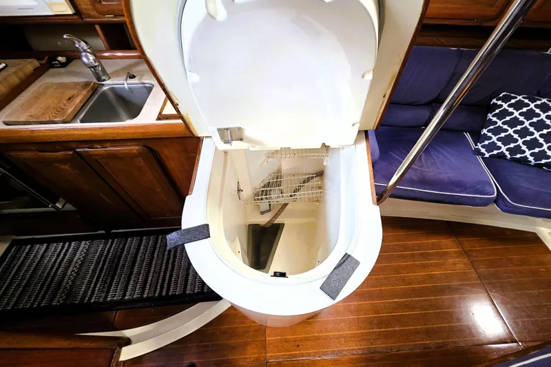 Slide: The Image of Interior of 1992 Hunter 43 Legend yacht, featuring a compact kitchen and seating area. - 11