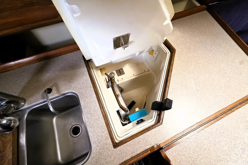 Slide: The Image of Open storage compartment in 1992 Hunter 43 Legend yacht kitchen, next to stainless steel sink. - 12