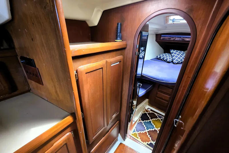 Slide: The Image of Cozy cabin interior of 1992 Hunter 43 Legend sailboat with wooden finish and colorful rug. - 17