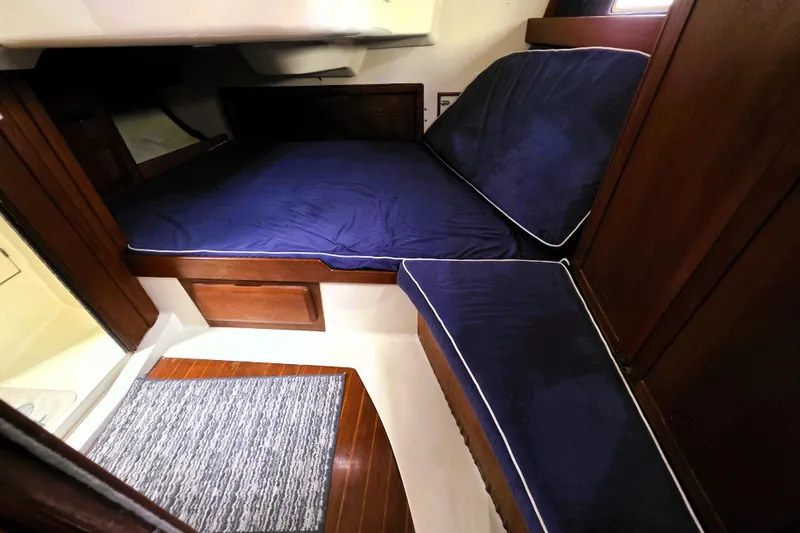 Slide: The Image of Interior cabin of 1992 Hunter 43 Legend sailboat with blue cushions and wooden accents. - 19