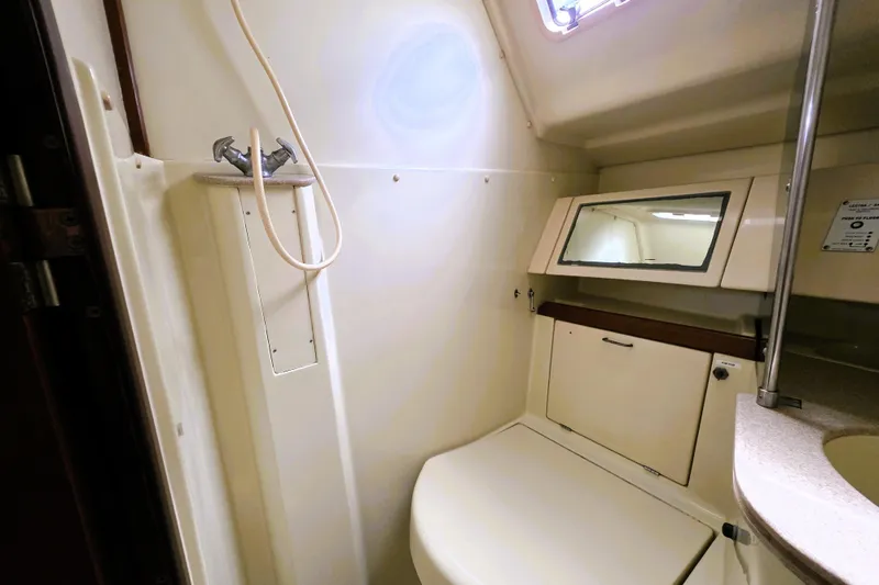 Slide: The Image of 1992 Hunter 43 Legend yacht bathroom with shower, mirror, and storage cabinet. - 21