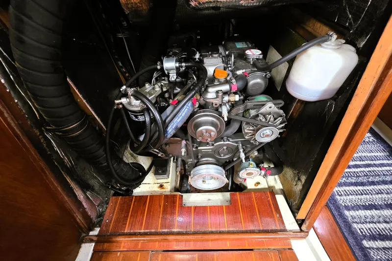 Slide: The Image of Engine compartment of a 1992 Hunter 43 Legend sailboat, showcasing detailed mechanical components. - 22