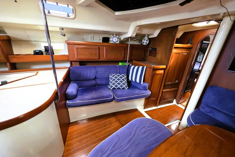 Slide: The Image of Interior of 1992 Hunter 43 Legend yacht with blue seating and wooden cabinetry. - 25