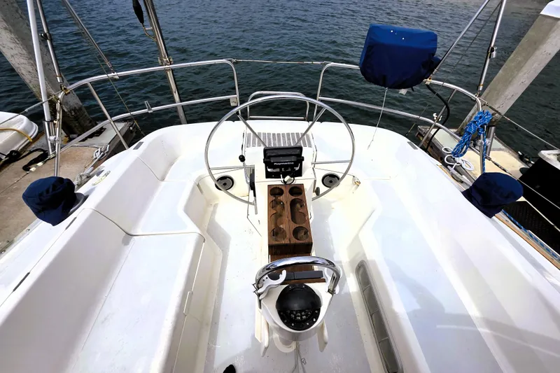 Slide: The Image of Cockpit of 1992 Hunter 43 Legend sailboat with steering wheel and navigation equipment. - 26
