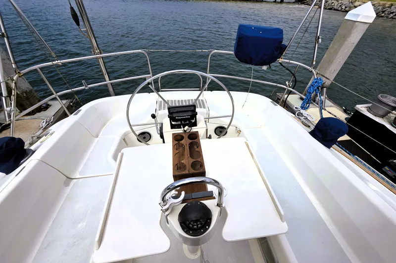 Slide: The Image of Cockpit of 1992 Hunter 43 Legend sailboat with steering wheel and navigation equipment. - 27
