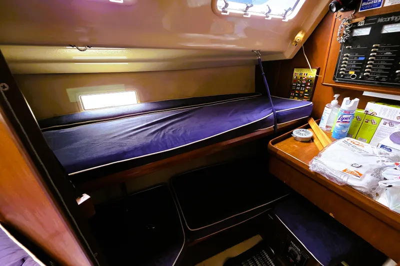 Slide: The Image of Interior cabin of a 1992 Hunter 43 Legend sailboat with a cozy bunk and navigation panel. - 4