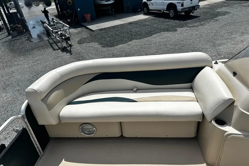 Slide: The Image of 2016 Godfrey Sweetwater 2086 Pontoon boat seating area with beige and blue upholstery. - 10