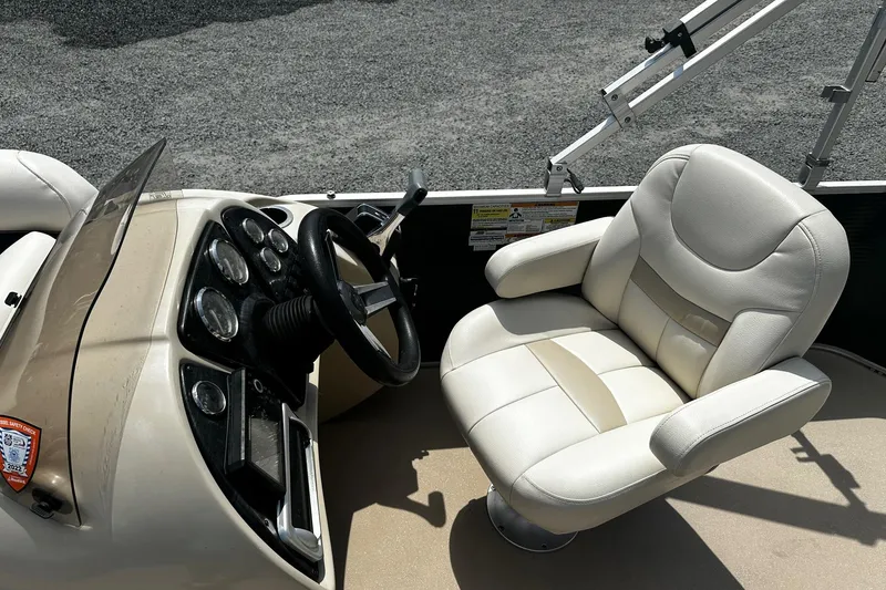 Slide: The Image of 2016 Godfrey Sweetwater 2086 Pontoon boat interior with steering console and plush captain's chair. - 4