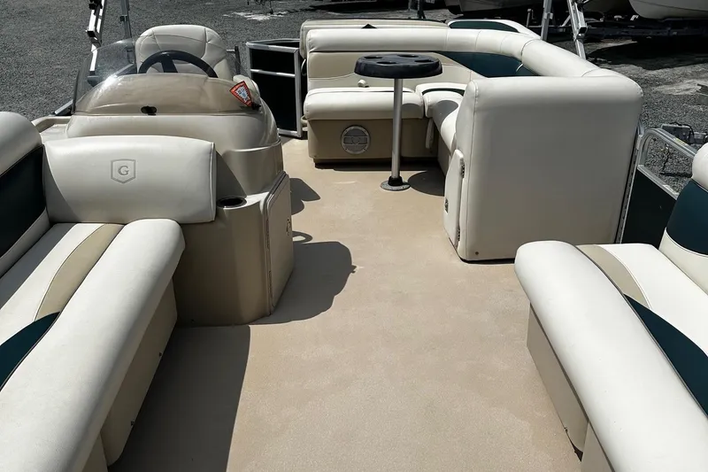 Slide: The Image of 2016 Godfrey Sweetwater 2086 Pontoon interior with beige seating and steering console. - 6