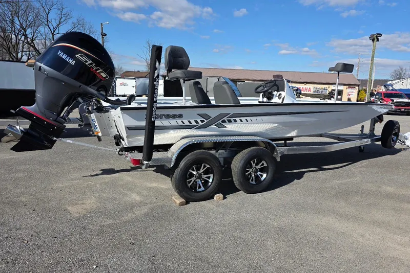 The Image of 2026 Xpress H20 Bass boat with Yamaha engine on a trailer, parked outdoors. - 0