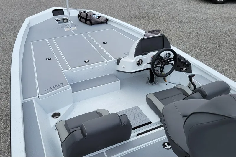 Slide: The Image of 2026 Xpress H20 Bass boat interior with seating and storage compartments. - 11