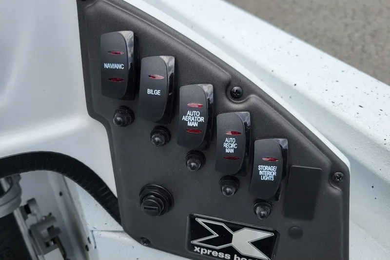 Slide: The Image of 2026 Xpress H20 Bass boat on trailer, parked outdoors. - 2