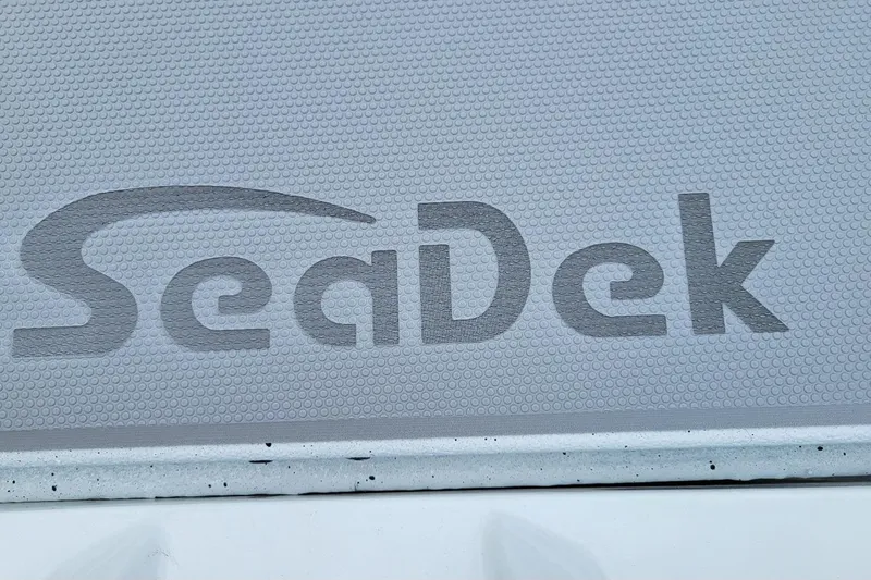 Slide: The Image of 2026 Xpress H20 Bass boat deck with textured surface and drain. - 8