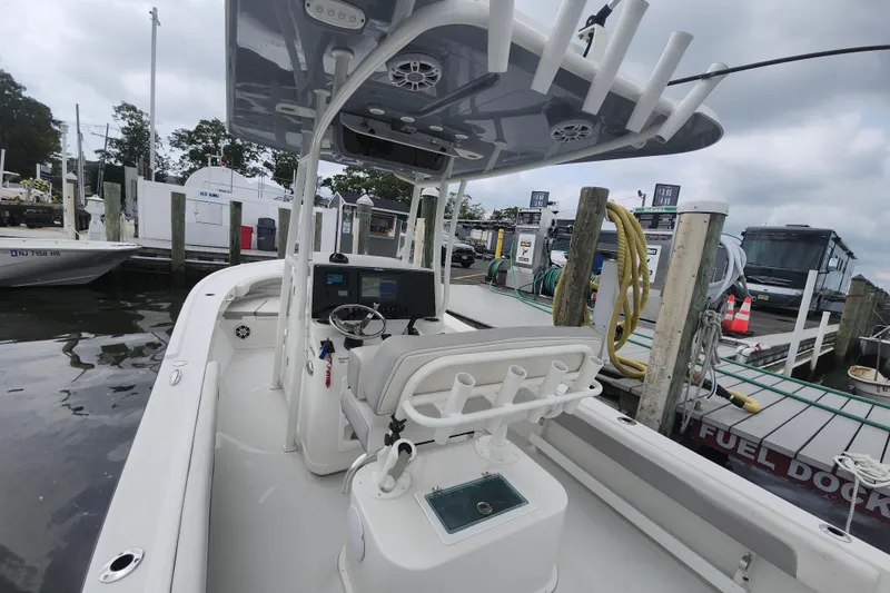 Slide: The Image of 2020 Parker 2300 Special Edition boat docked at marina, featuring modern console and seating. - 10
