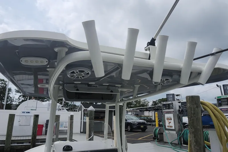 Slide: The Image of 2020 Parker 2300 Special Edition boat with rod holders and speakers at a marina. - 22