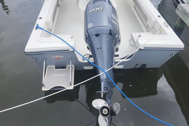 Slide: The Image of 2020 Parker 2300 Special Edition boat with Yamaha 200 engine, docked on calm water. - 5