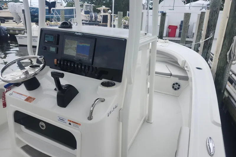 Slide: The Image of 2020 Parker 2300 Special Edition boat dashboard with navigation controls at marina. - 8