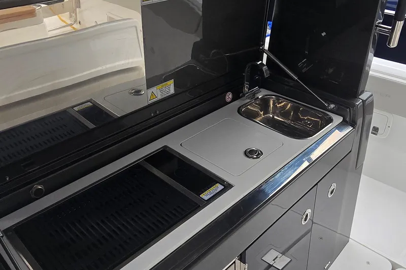 Slide: The Image of 2025 Schaefer V33 yacht kitchen area with sink and grill. - 10