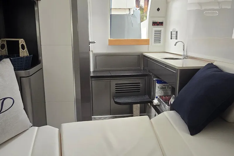 Slide: The Image of Interior of 2025 Schaefer V33 yacht featuring modern kitchenette and seating area. - 11