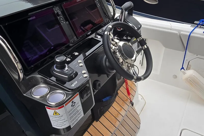 Slide: The Image of 2025 Schaefer V33 boat cockpit with advanced controls and steering wheel. - 8