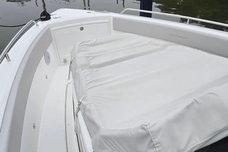 Slide: The Image of 2025 Schaefer V33 boat deck with cushioned seating and protective cover. - 9