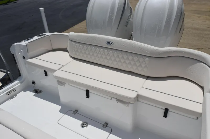 Slide: The Image of 2026 Sea Hunt Ultra 275 SE boat with cushioned seating and dual outboard engines. - 14