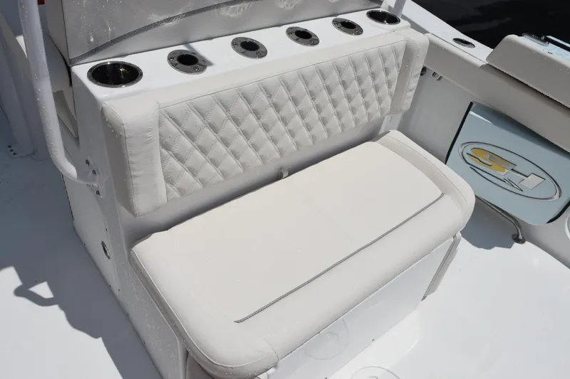 Slide: The Image of 2026 Sea Hunt Ultra 275 SE boat seating with cup holders and quilted upholstery. - 15