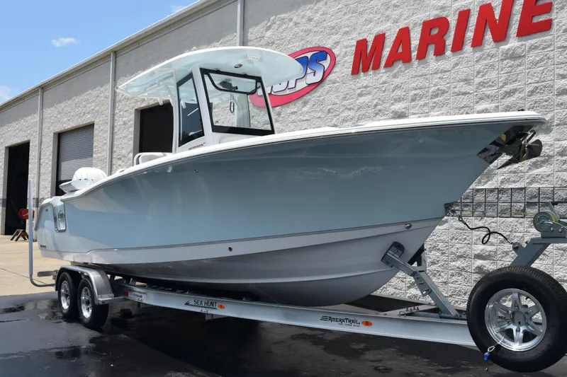 Slide: The Image of 2026 Sea Hunt Ultra 275 SE boat on trailer outside marine dealership. - 2