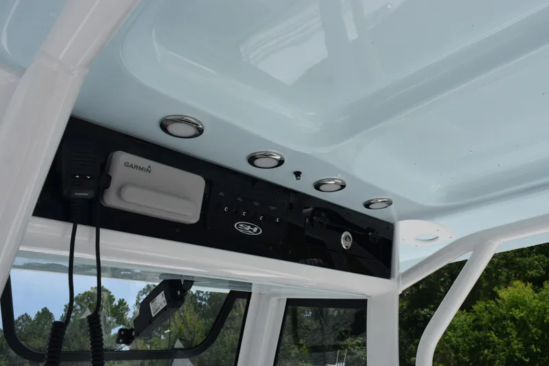 Slide: The Image of 2026 Sea Hunt Ultra 275 SE boat console with Garmin electronics and overhead lighting. - 26