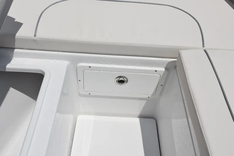 Slide: The Image of 2026 Sea Hunt Ultra 275 SE boat interior storage compartment with cushioned seating. - 28