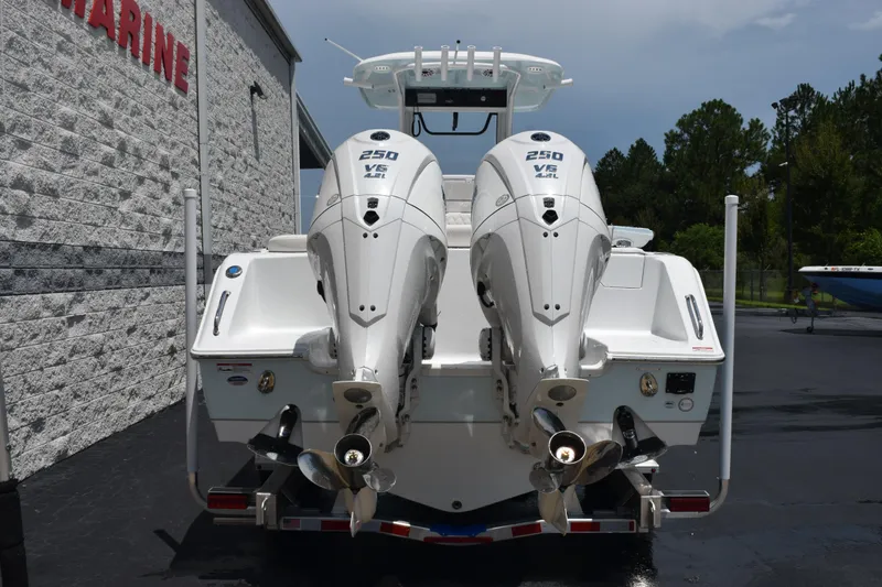 Slide: The Image of 2026 Sea Hunt Ultra 275 SE boat with dual 250 V6 engines, parked outdoors. - 5