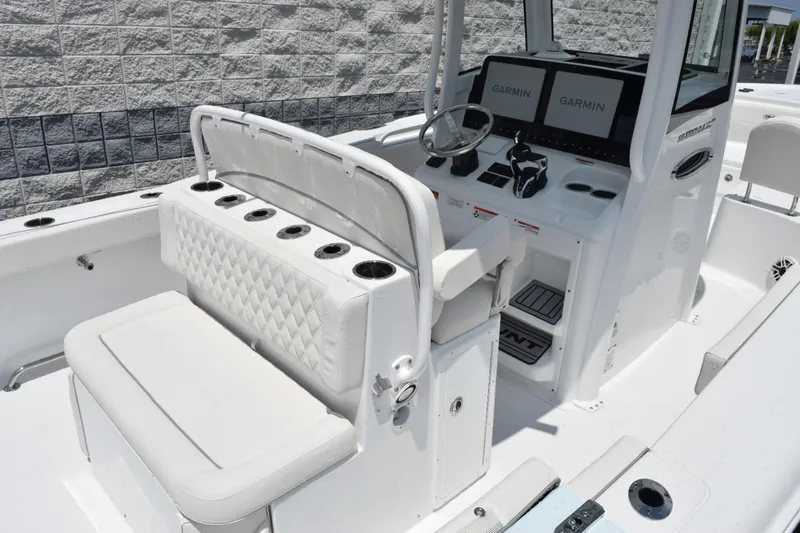Slide: The Image of 2026 Sea Hunt Ultra 275 SE boat interior with Garmin displays and cushioned seating. - 7