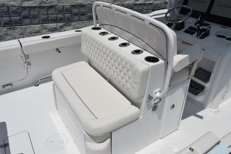 Slide: The Image of 2026 Sea Hunt Ultra 275 SE boat interior with cushioned seating and cup holders. - 8
