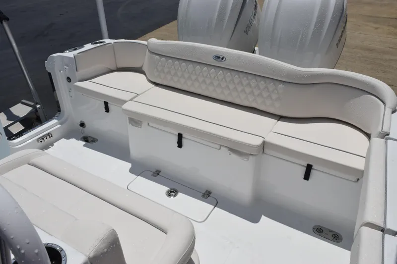 Slide: The Image of 2026 Sea Hunt Ultra 275 SE boat interior with cushioned seating and dual engines. - 9