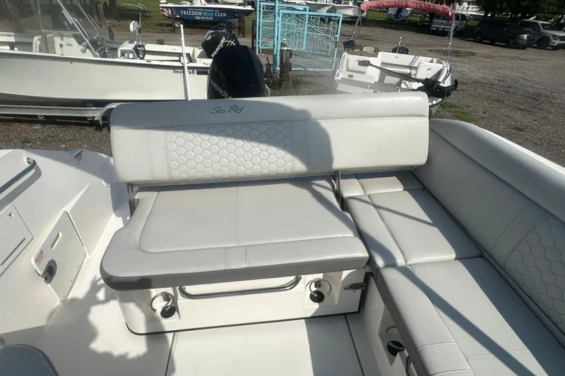 Slide: The Image of 2023 Sea Ray SDX 250 Outboard boat interior with white seating and storage. - 19