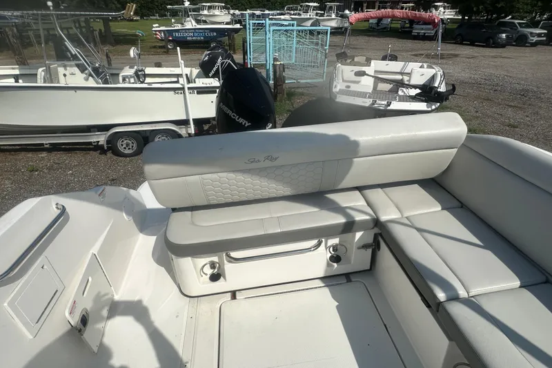 Slide: The Image of 2023 Sea Ray SDX 250 Outboard boat interior with white seating and Mercury engine. - 21