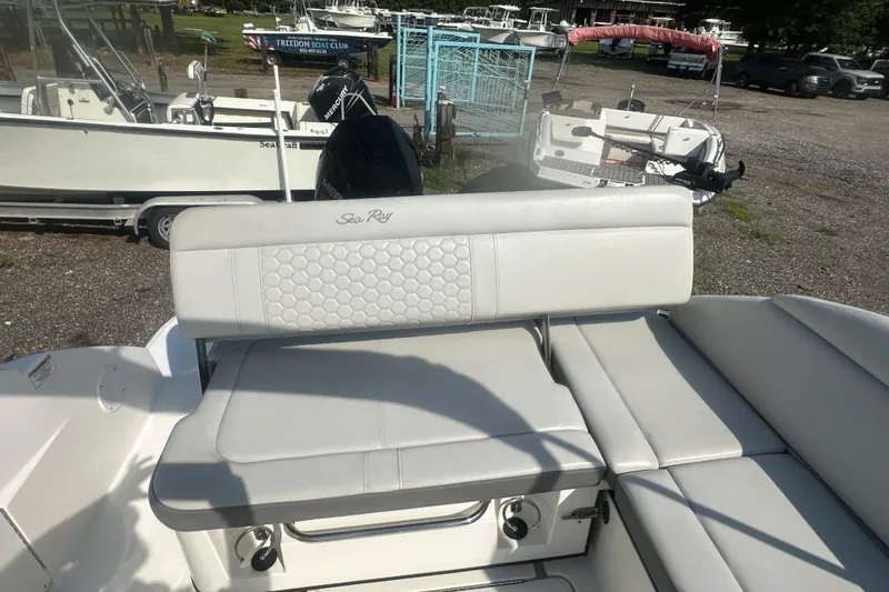 Slide: The Image of 2023 Sea Ray SDX 250 Outboard boat with white seating and sleek design. - 22